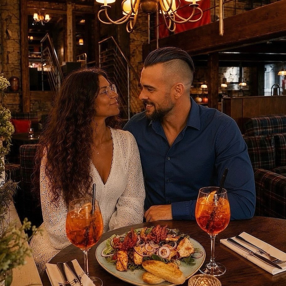 Couple at a restaurant table sharing food and drinks