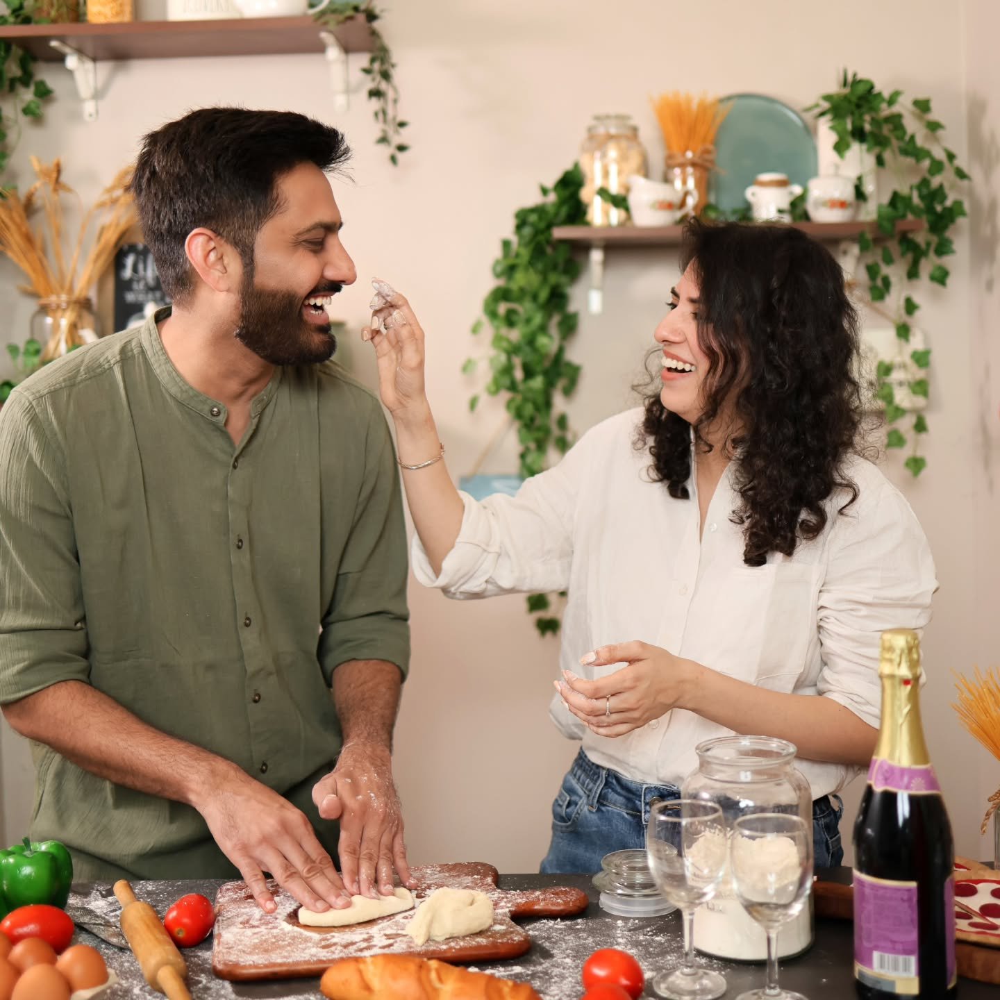 Couple making dough together in a kitchen