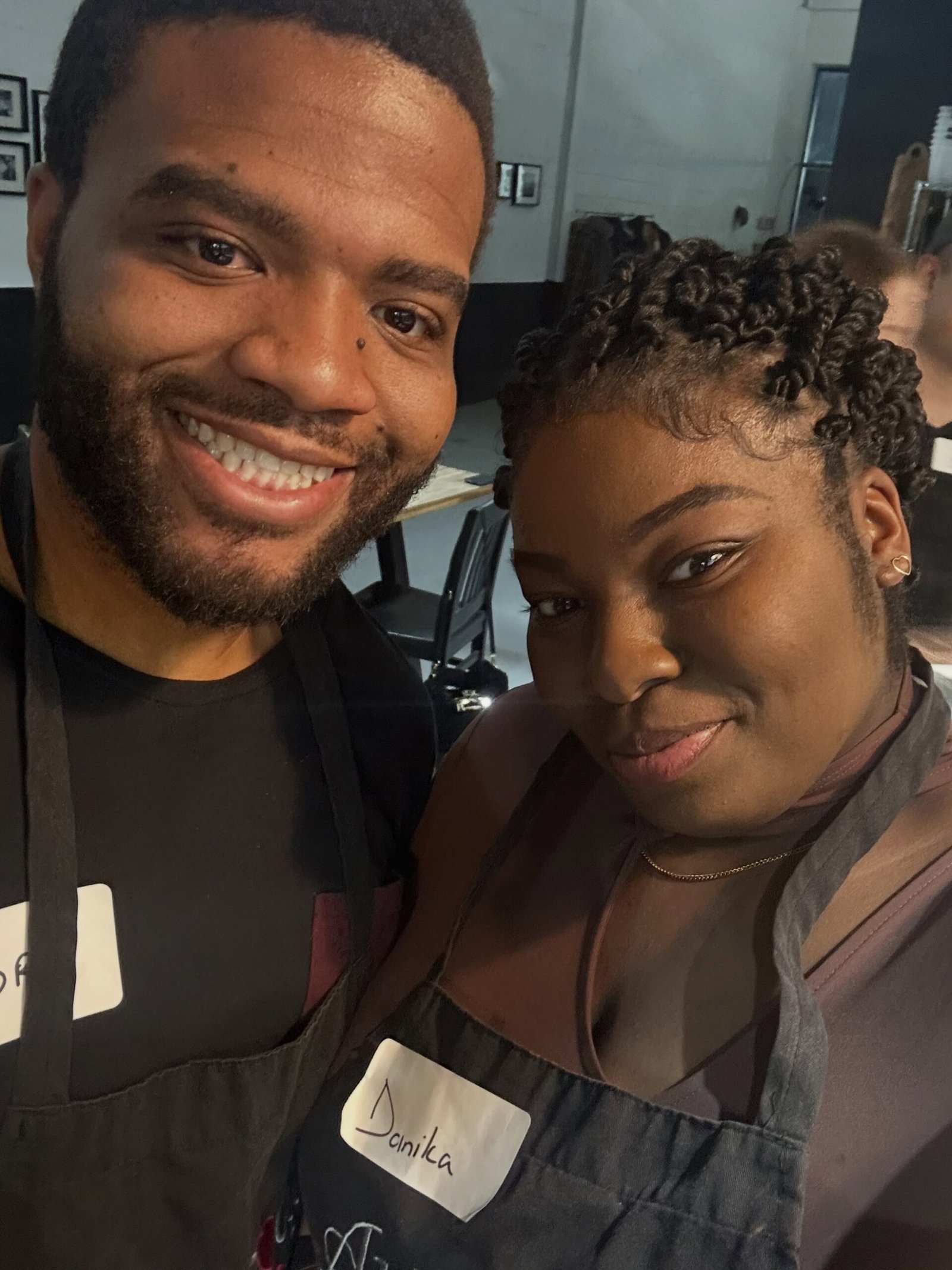 Couple selfie in aprons in a cooking class kitchen