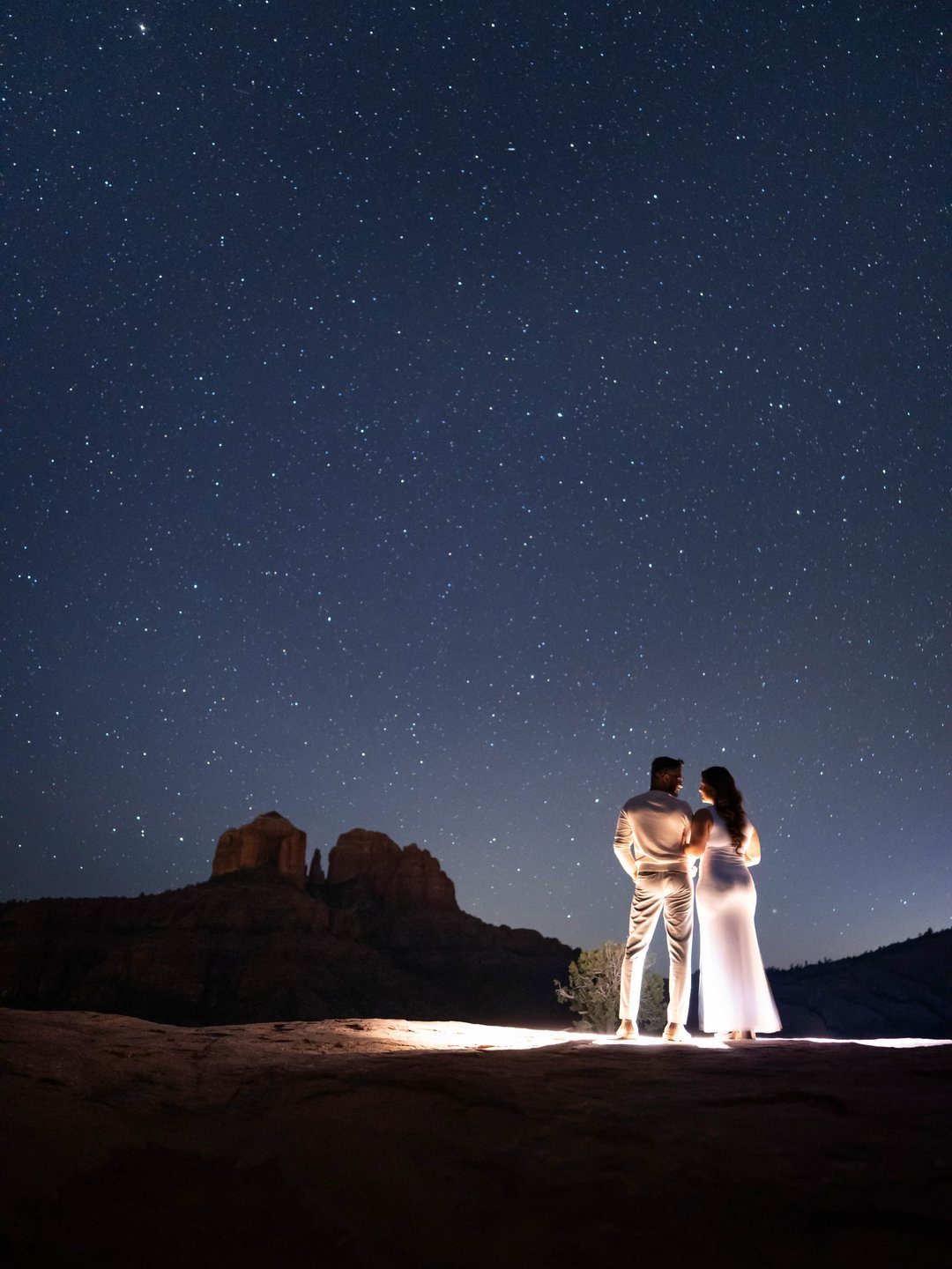 Couple in white under a starry night sky
