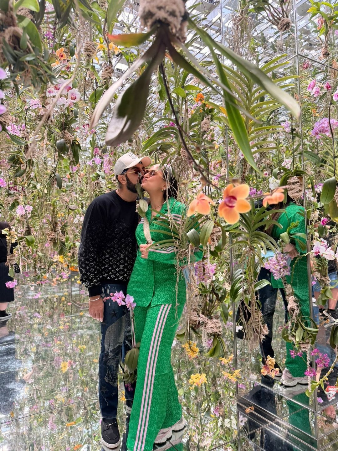 Couple kissing inside an immersive floral art exhibit