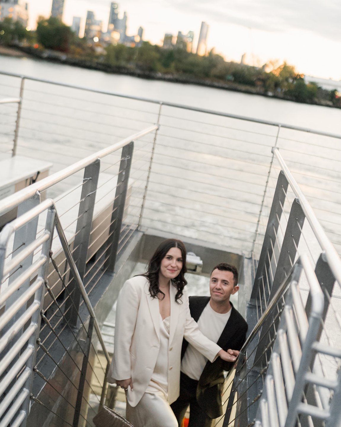 Couple on a ferry with the city skyline at dusk