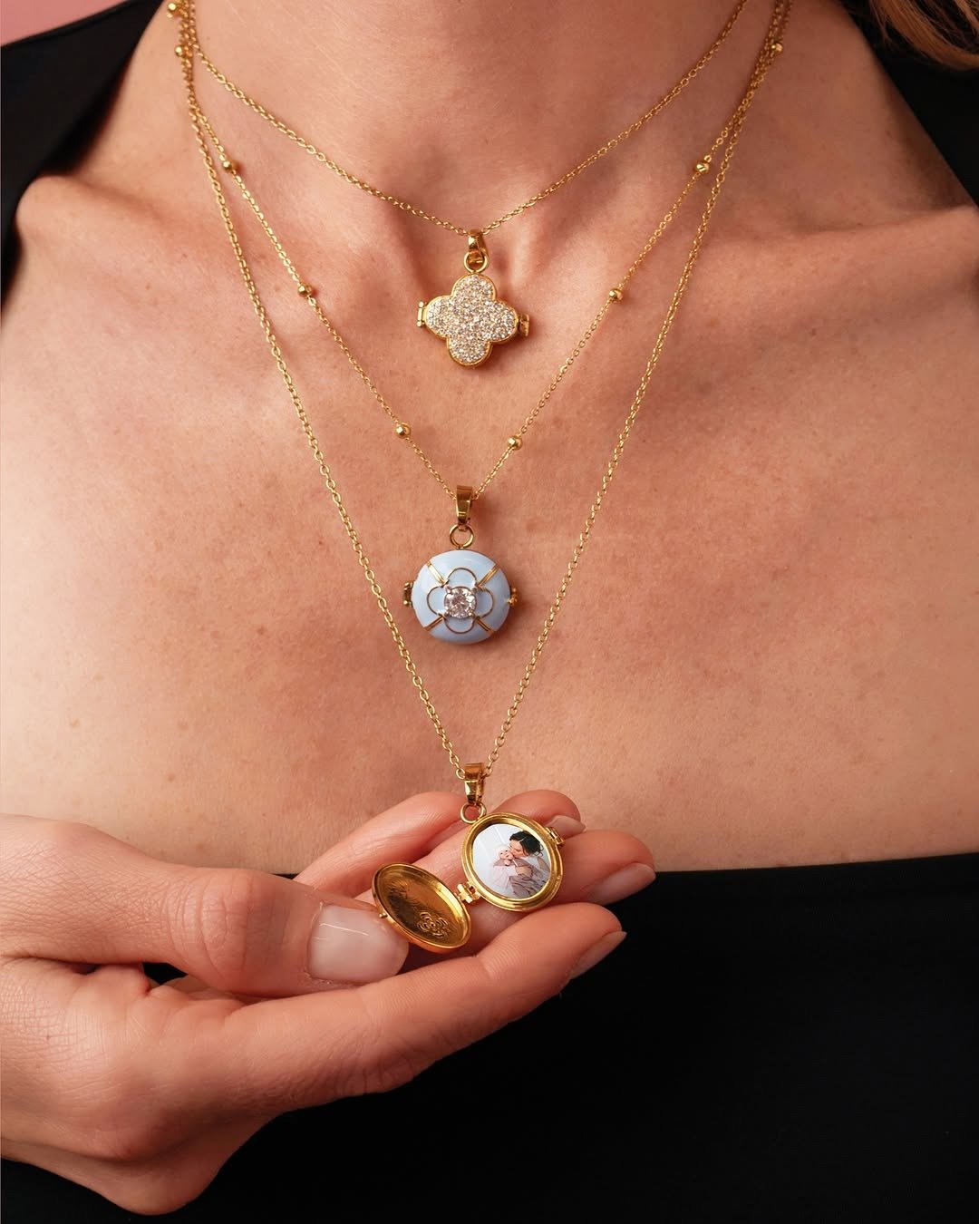 Woman holding open locket with tiny photo inside
