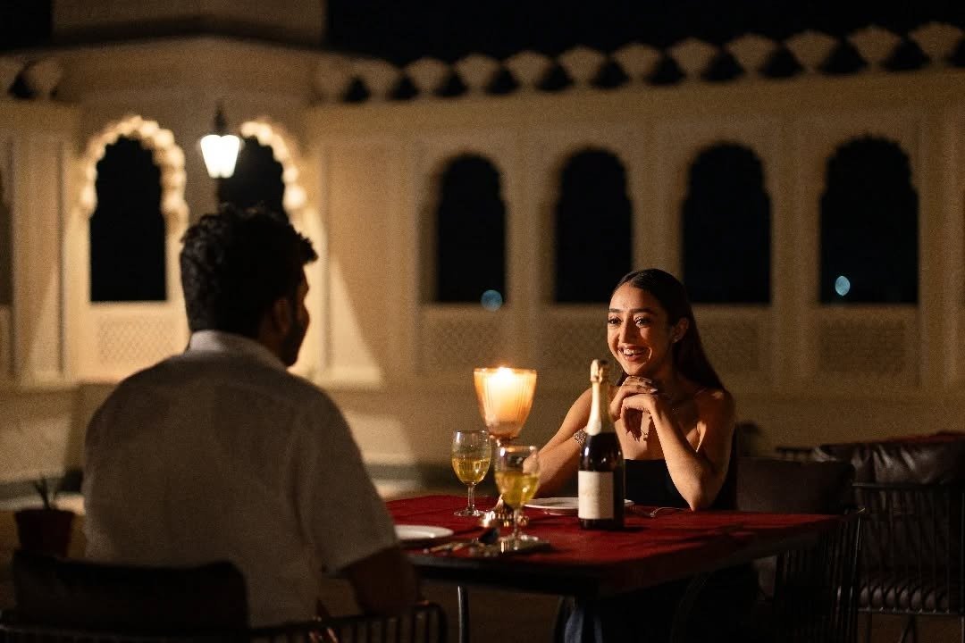 Couple at candlelit terrace dinner with wine