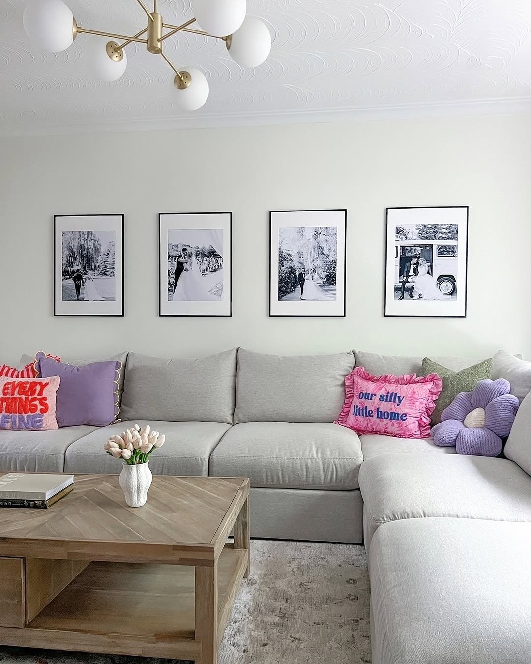 Framed wedding photos of couple above sofa