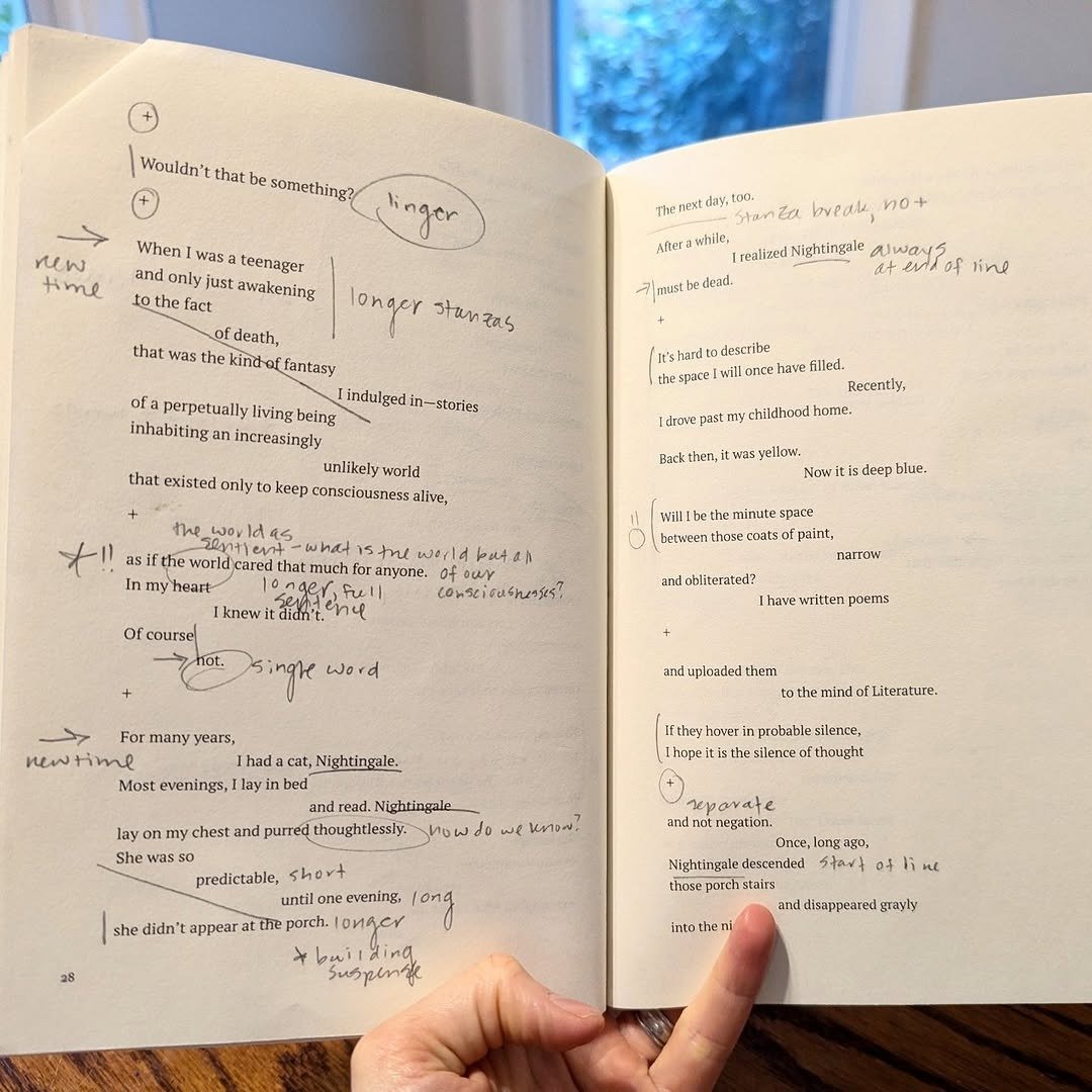 Open poem book covered in handwritten margin notes