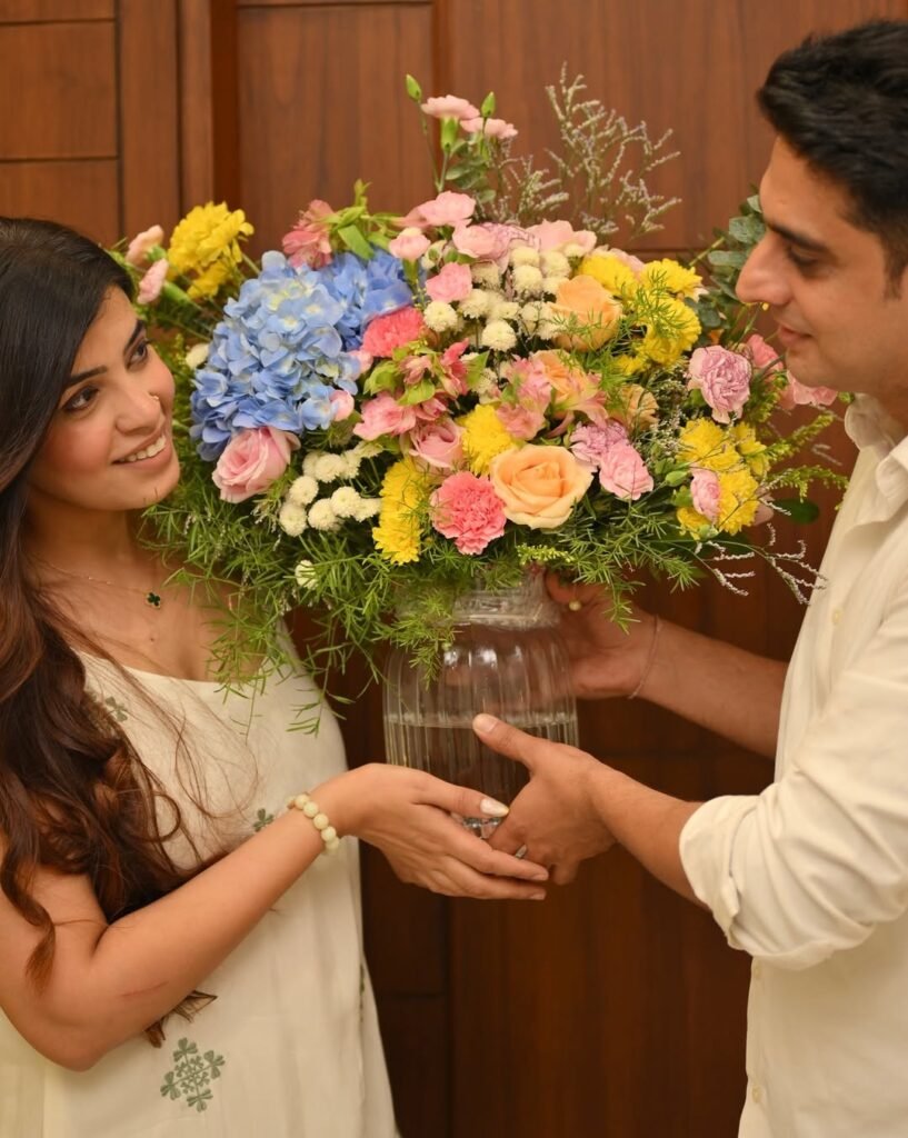 Husband giving wife a bouquet of flowers at home