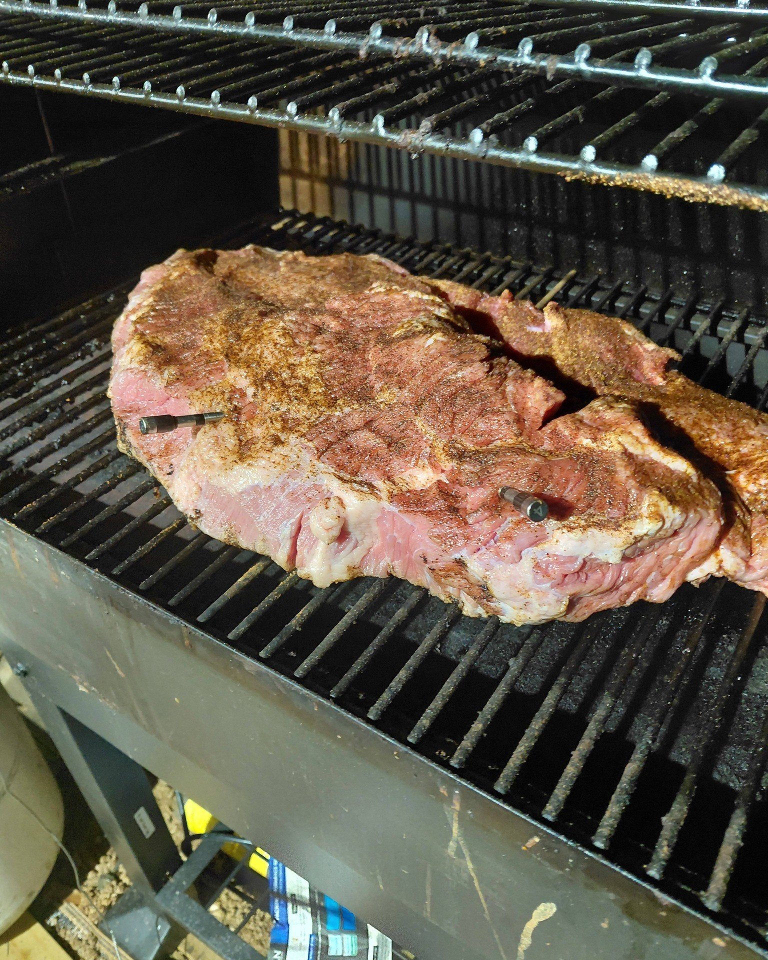 Brisket on grill with wireless thermometer probes