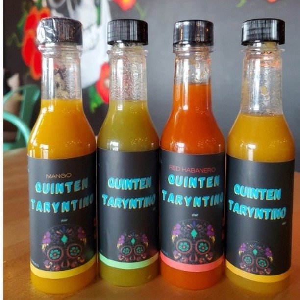 Four hot sauce bottles gift pack on wood