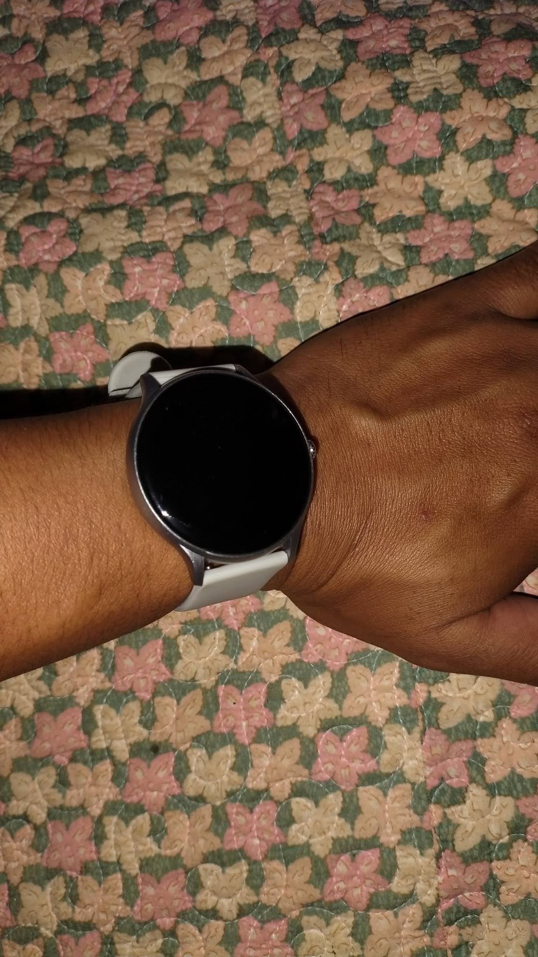 Smartwatch with white strap on a wrist